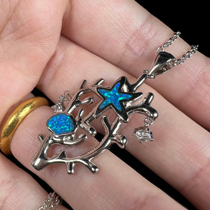 A silver plated coral reef necklace with blue lab-created opal inlay and CZ accents.