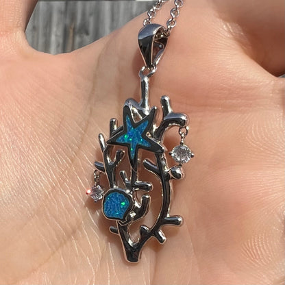A silver plated coral reef necklace with blue lab-created opal inlay and CZ accents.