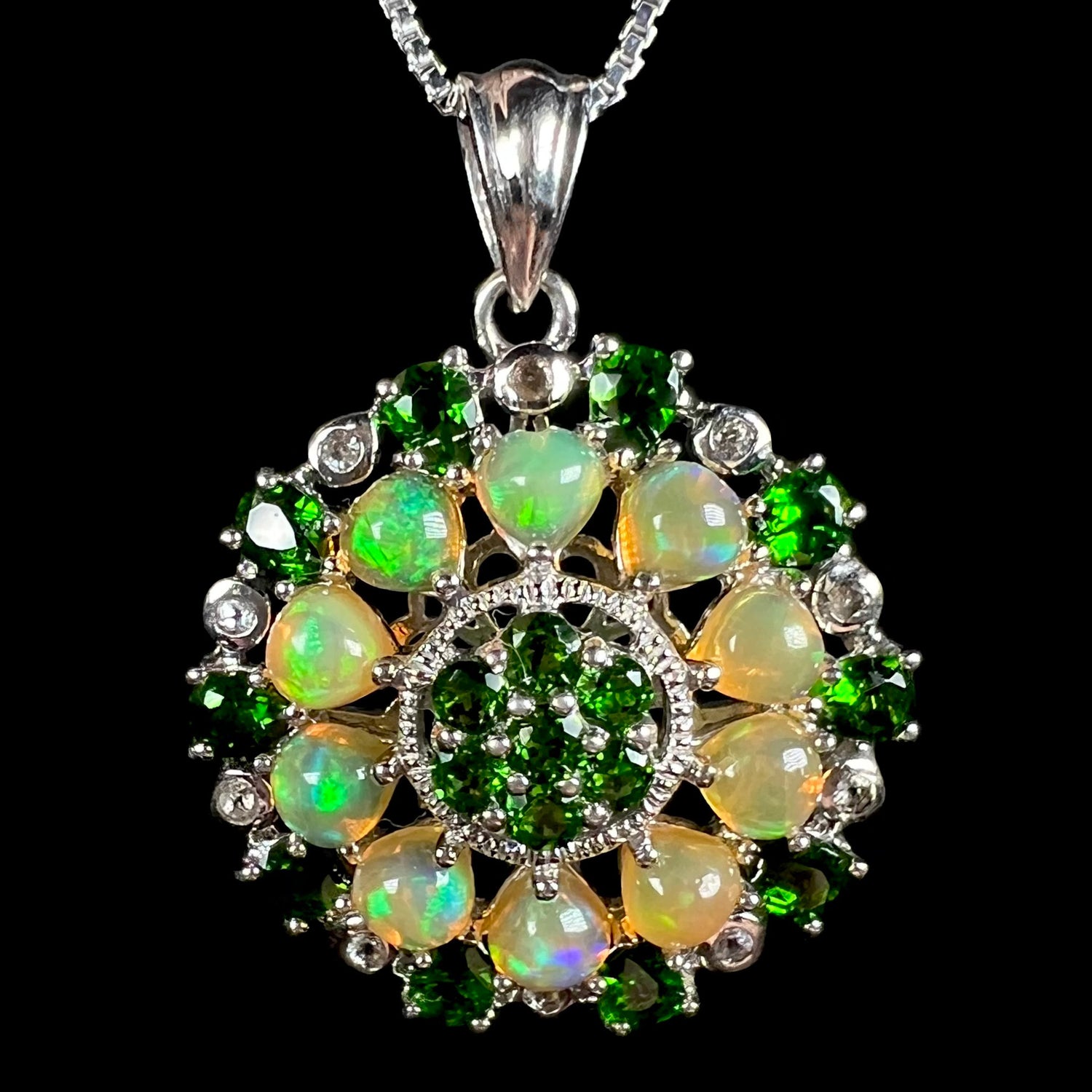 A sterling silver Ethiopian opal medallion pendant with green chrome diopside accents.