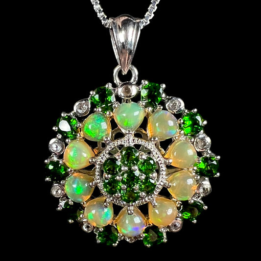 A sterling silver Ethiopian opal medallion pendant with green chrome diopside accents.