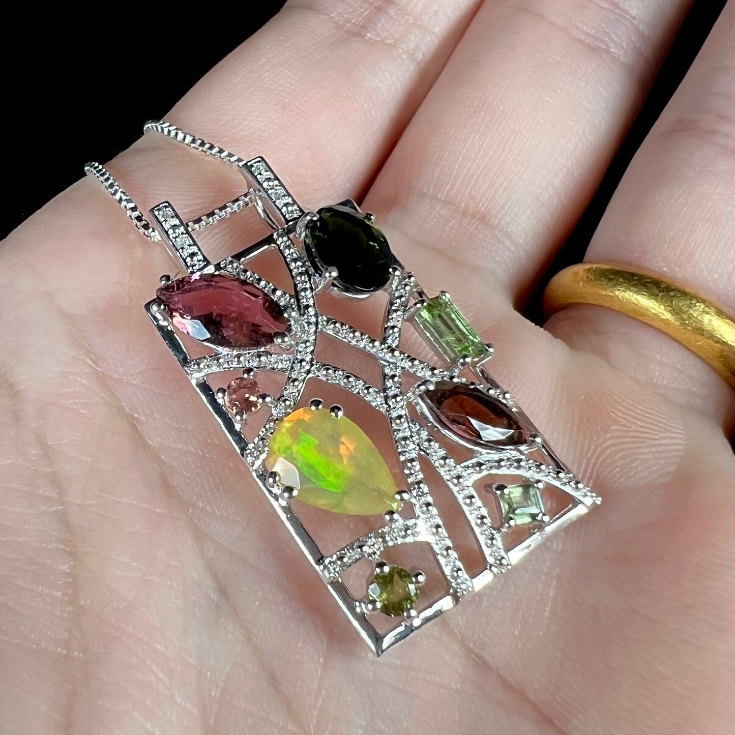 A sterling silver multi-gemstone necklace set with Ethiopian opal, tourmaline, and diamonds.