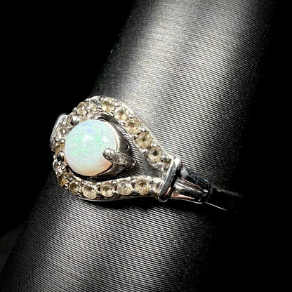 Angled close-up of Australian opal and smoky quartz ring in sterling silver, shown on ring display