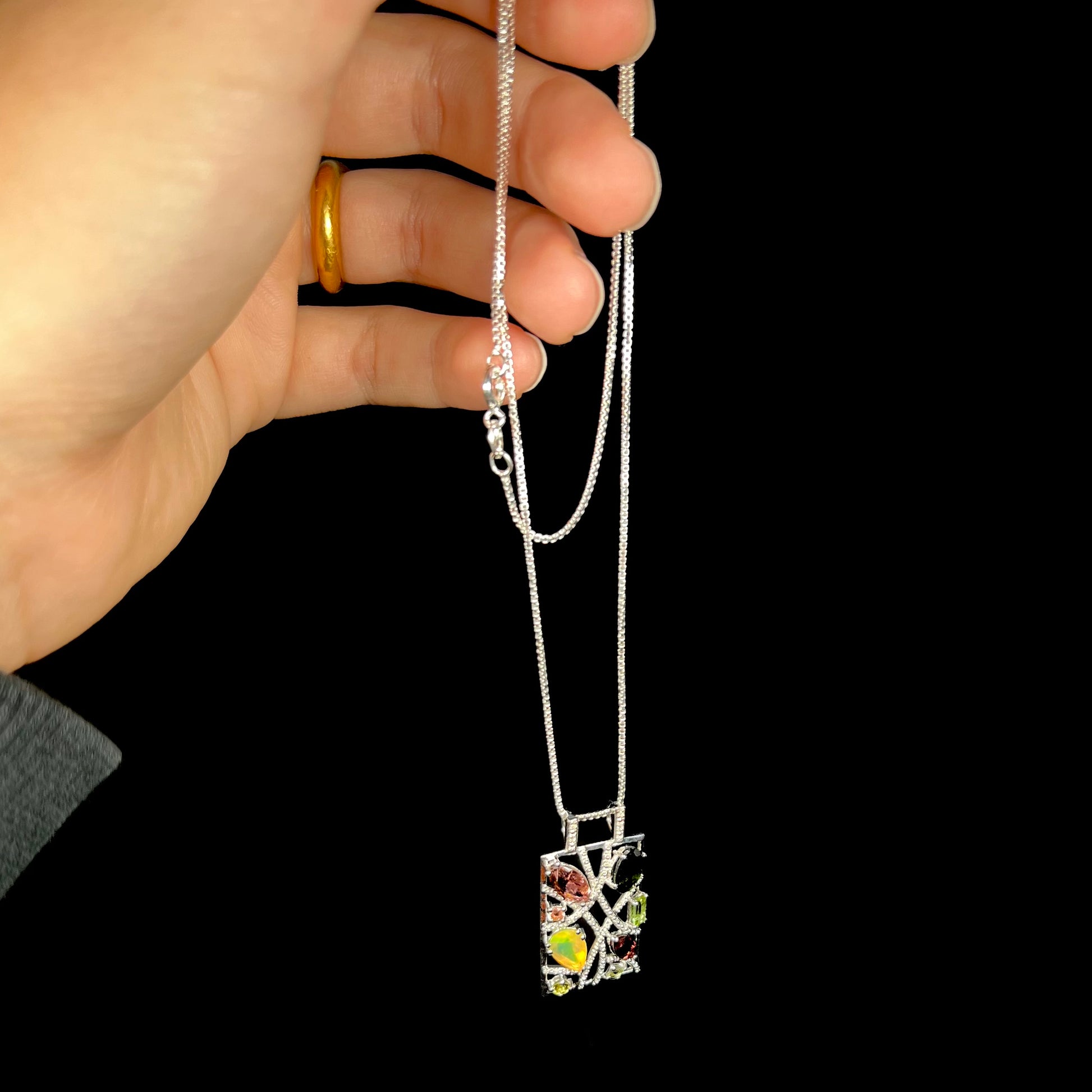 A sterling silver multi-gemstone necklace set with Ethiopian opal, tourmaline, and diamonds.