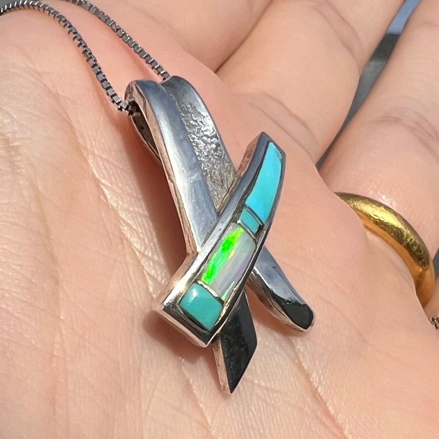 A folded design sterling silver turquoise and lab-created opal inlay necklace.