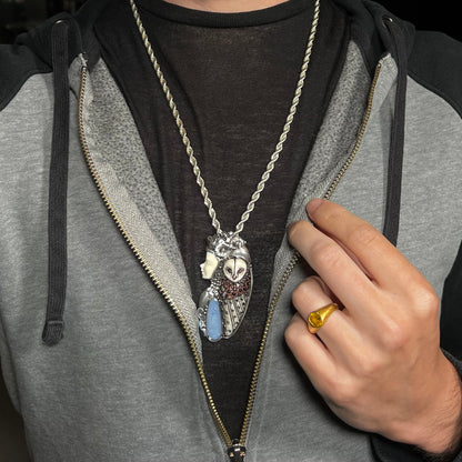 A woman and owl necklace with a nature-inspired motif, made from sterling silver, bone, and an opal doublet.