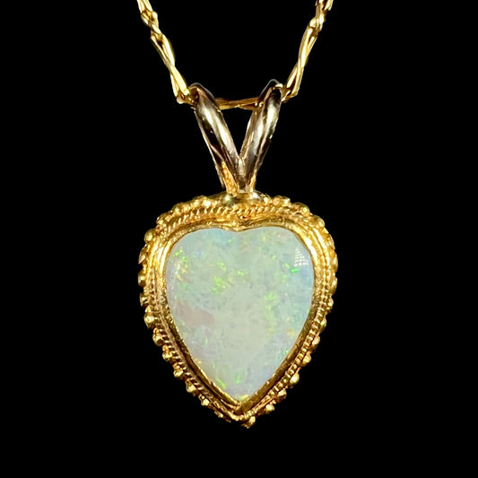 An 18 karat yellow gold heart necklace mounted with a heart shaped opal.