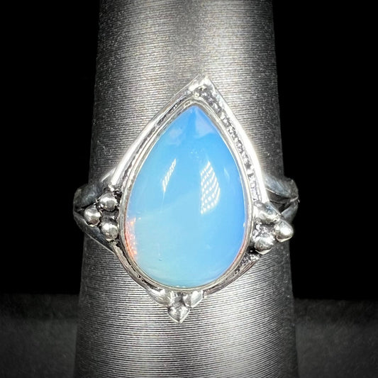 A handmade white metal ring set with a pear shaped opalite cabochon.