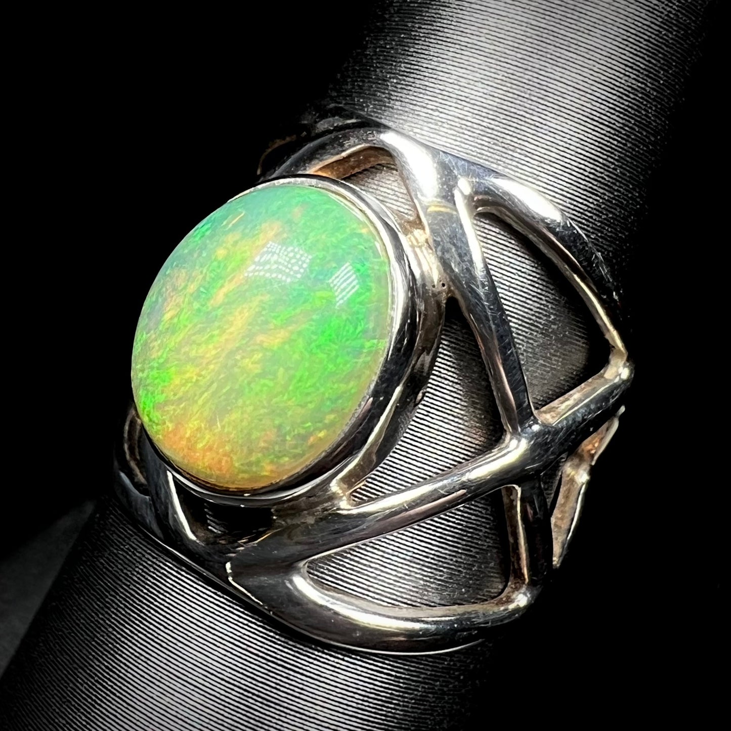 An open design Ethiopian opal ring made from sterling silver, shown at an angle.