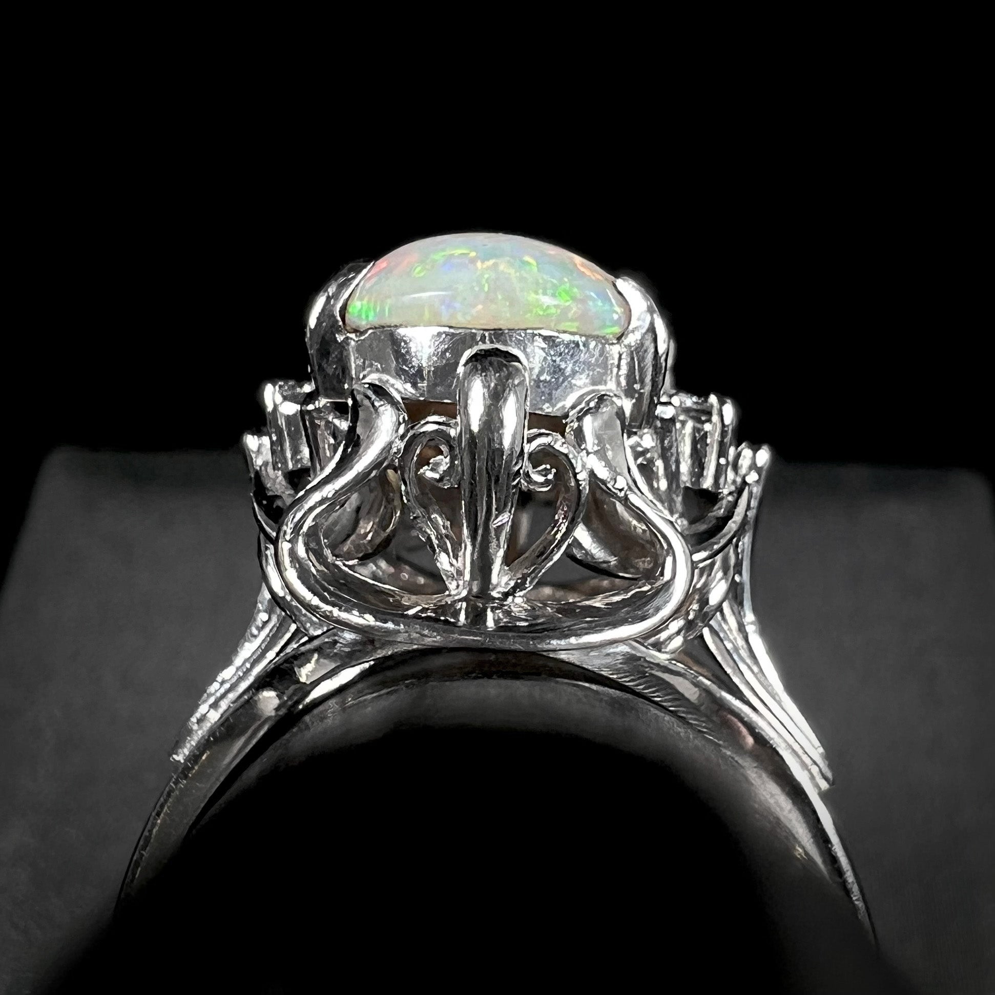 Ornate Japanese designs on the gallery of a platinum opal and diamond-accented ring.