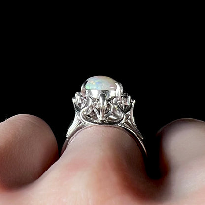 A Japanese-style platinum ring mounted with a Coober Pedy opal and diamond accents.