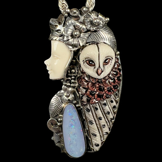 Carved bone woman and owl necklace with nature-inspired motif, set with an opal doublet shown from the front.