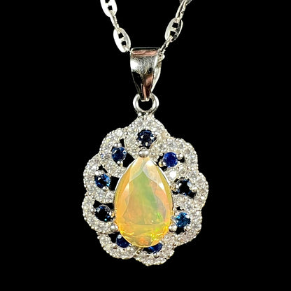 Close-up of women's sterling silver pear shaped Ethiopian opal, blue sapphire, and CZ necklace