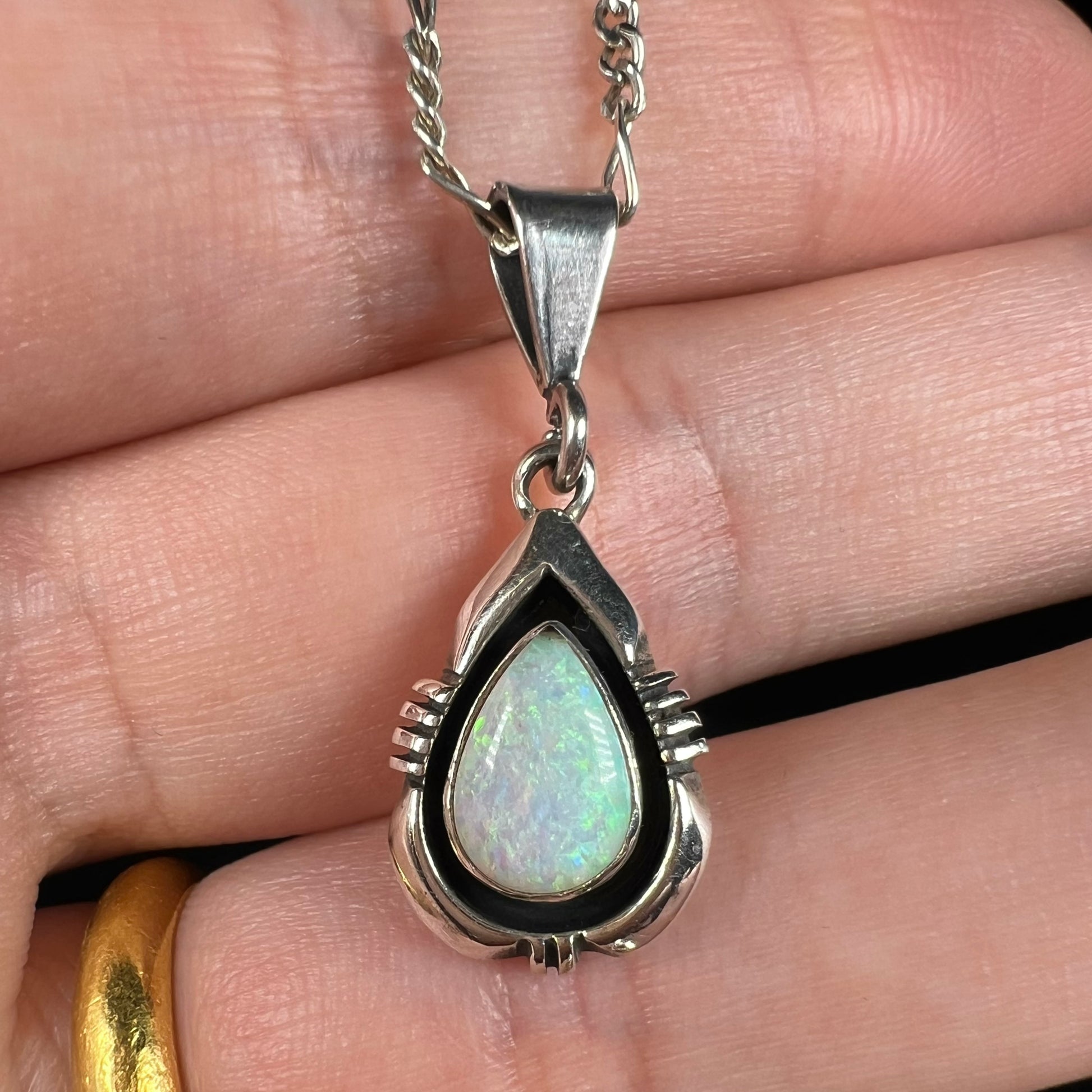 A pear shaped sterling silver Navajo pendant set with a green Australian opal made by artist, Chris Charley.