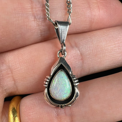 A pear shaped sterling silver Navajo pendant set with a green Australian opal made by artist, Chris Charley.
