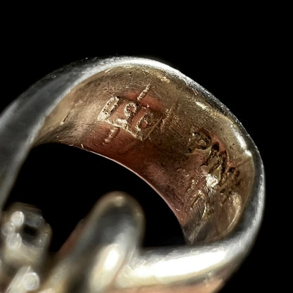 The inside view of a pendant's bail, hallmarked "950" and "PINK CITY".