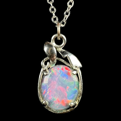Close-up of estate base metal opal triplet pendant with bright pinkish red flashes on chain