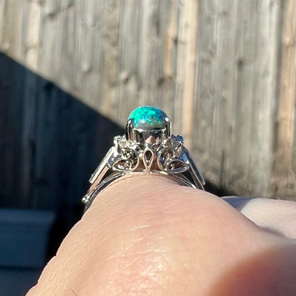 The gallery view showcasing filigree on a platinum black opal ring in the sunlight.