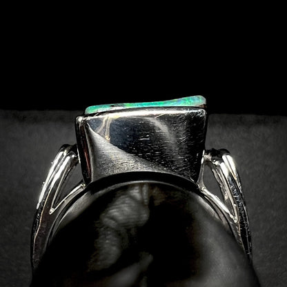 Gallery view of a platinum boulder opal ring on a ring display, shown against a black background.