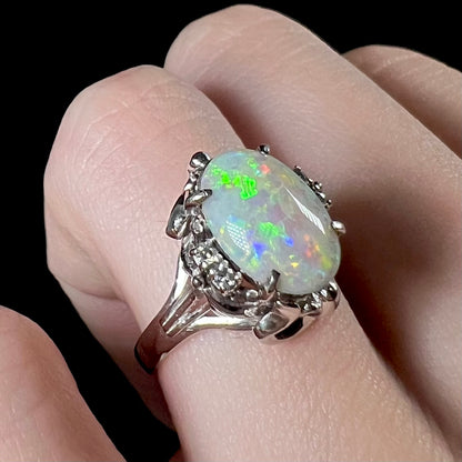 A Japanese-style platinum ring mounted with a Coober Pedy opal and diamond accents.