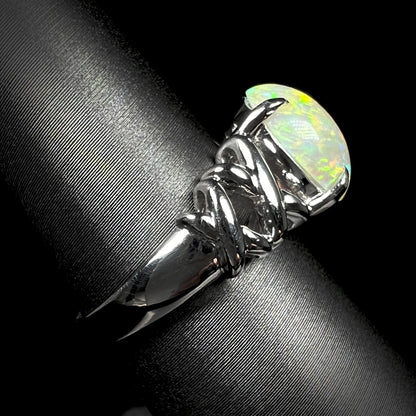 Side view of a platinum crisscross ring mounted with a 2.20ct opal.