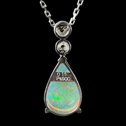 A platinum drop pendant mounted with two diamond accents and a pear shaped green-blue crystal opal.