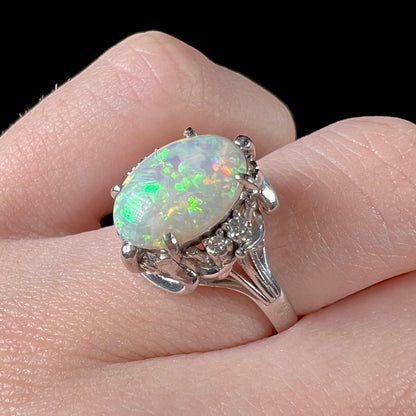 A Japanese-style platinum ring mounted with a Coober Pedy opal and diamond accents.