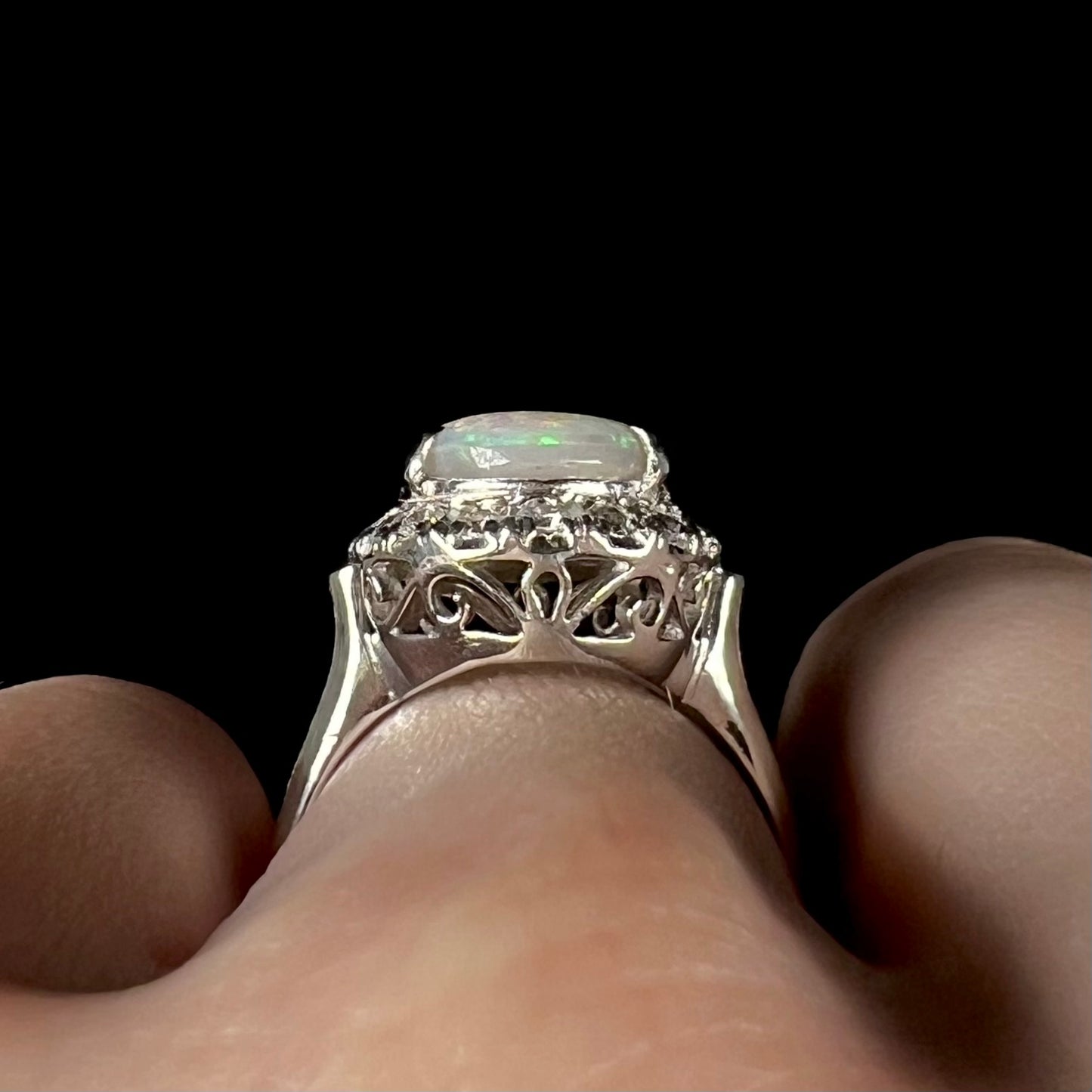 Platinum filigree on the gallery of a vintage opal and diamond engagement ring.