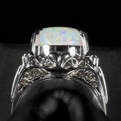 Gallery view of a platinum opal ring, showcasing intricate filigree design.