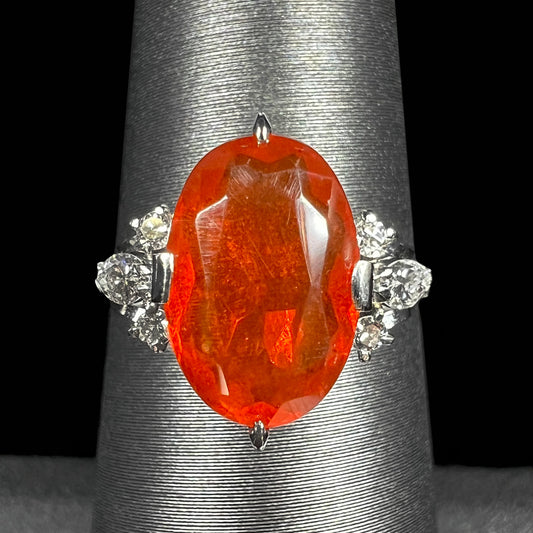 A Japanese Mid-Century fire opal and diamond platinum ring.  The opal has a bright orange body color.