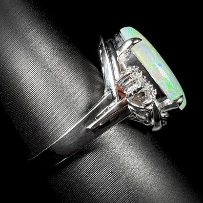 A platinum ring set with a 2.54ct Coober Pedy semi-crystal opal and diamond accents.