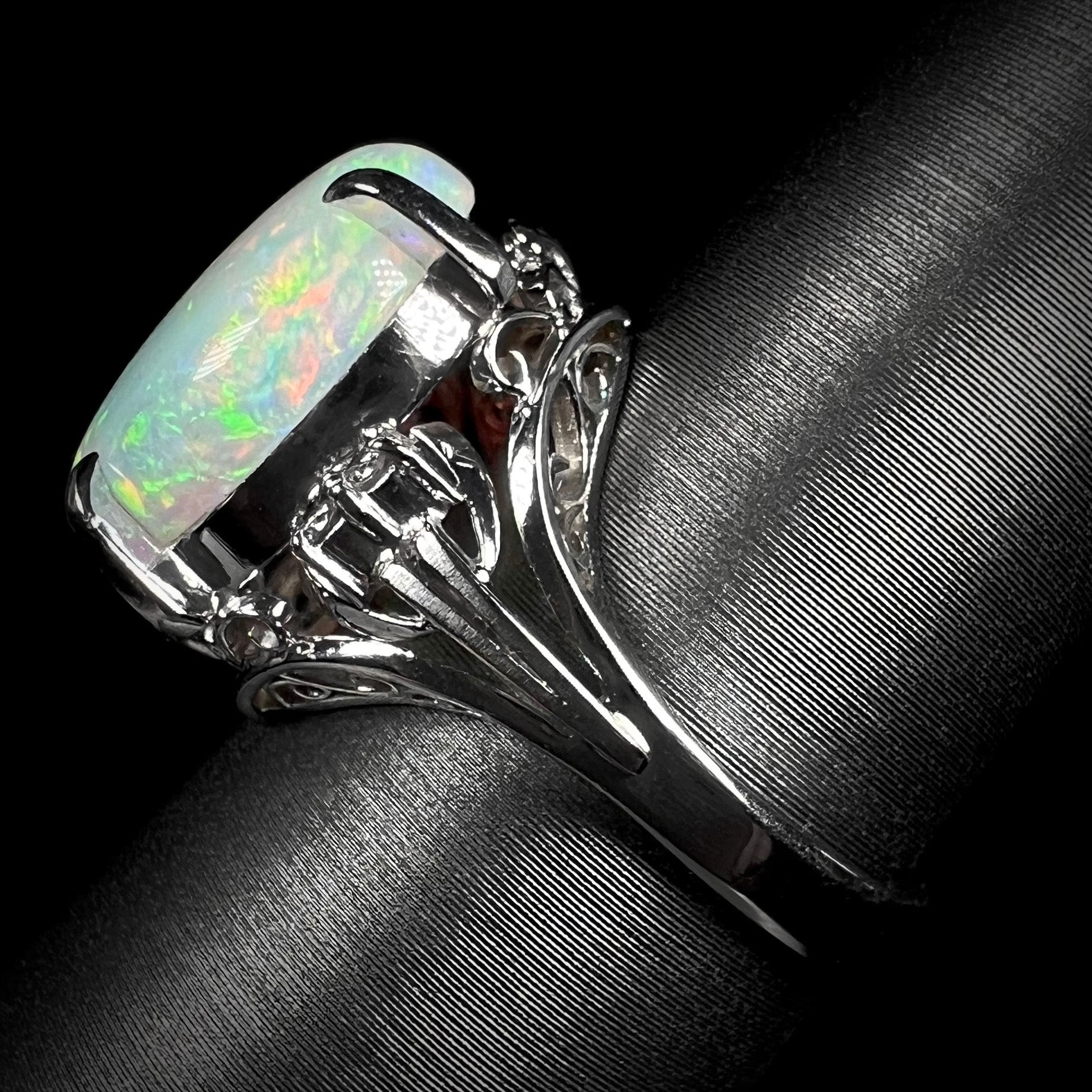 A platinum engagement ring set with a 4.83ct opal and diamond accents.