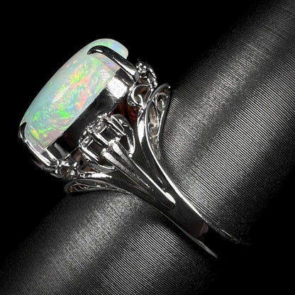 A platinum engagement ring set with a 4.83ct opal and diamond accents.