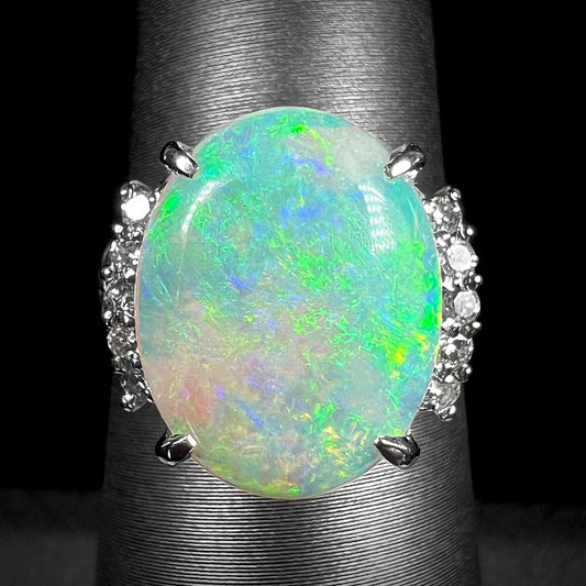 A platinum ring mounted with diamond accents and a 3.54ct Coober Pedy semi-crystal opal.