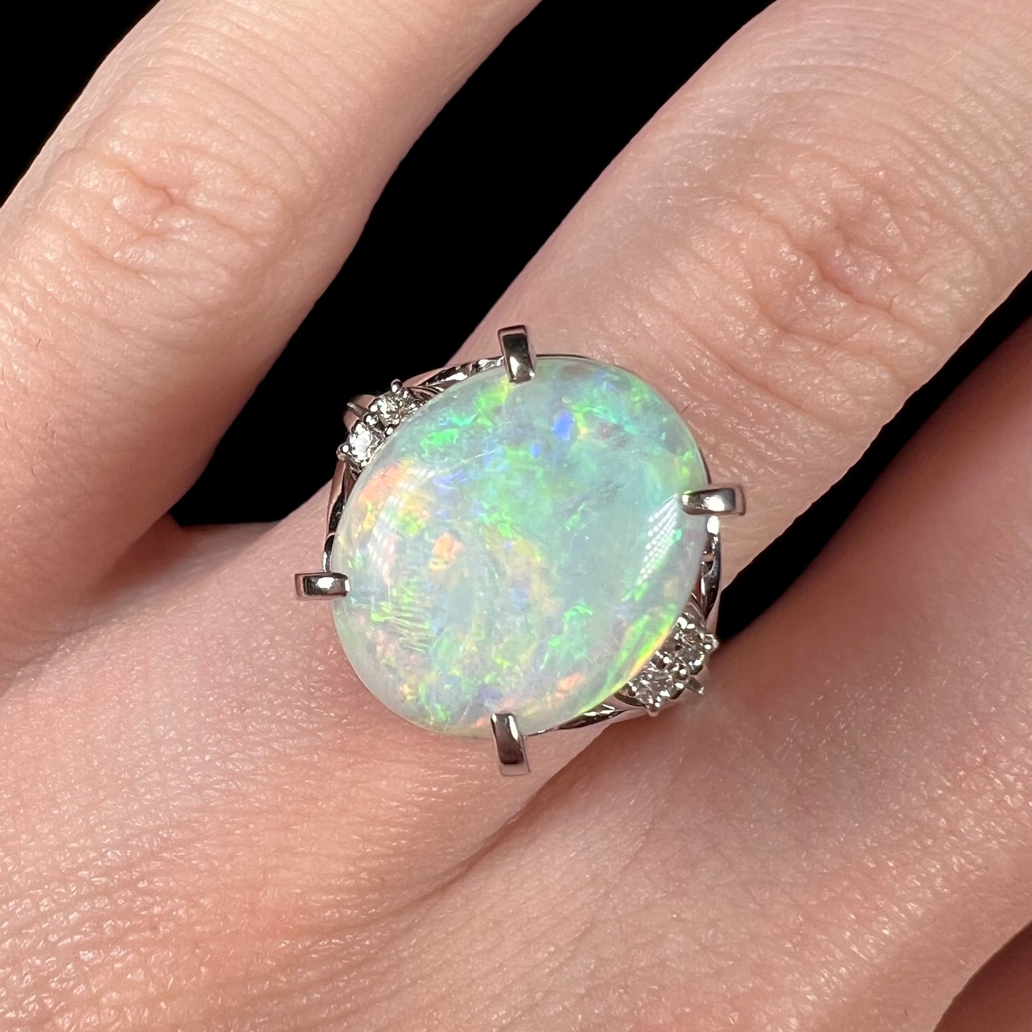 A platinum engagement ring set with a 4.83ct opal and diamond accents.