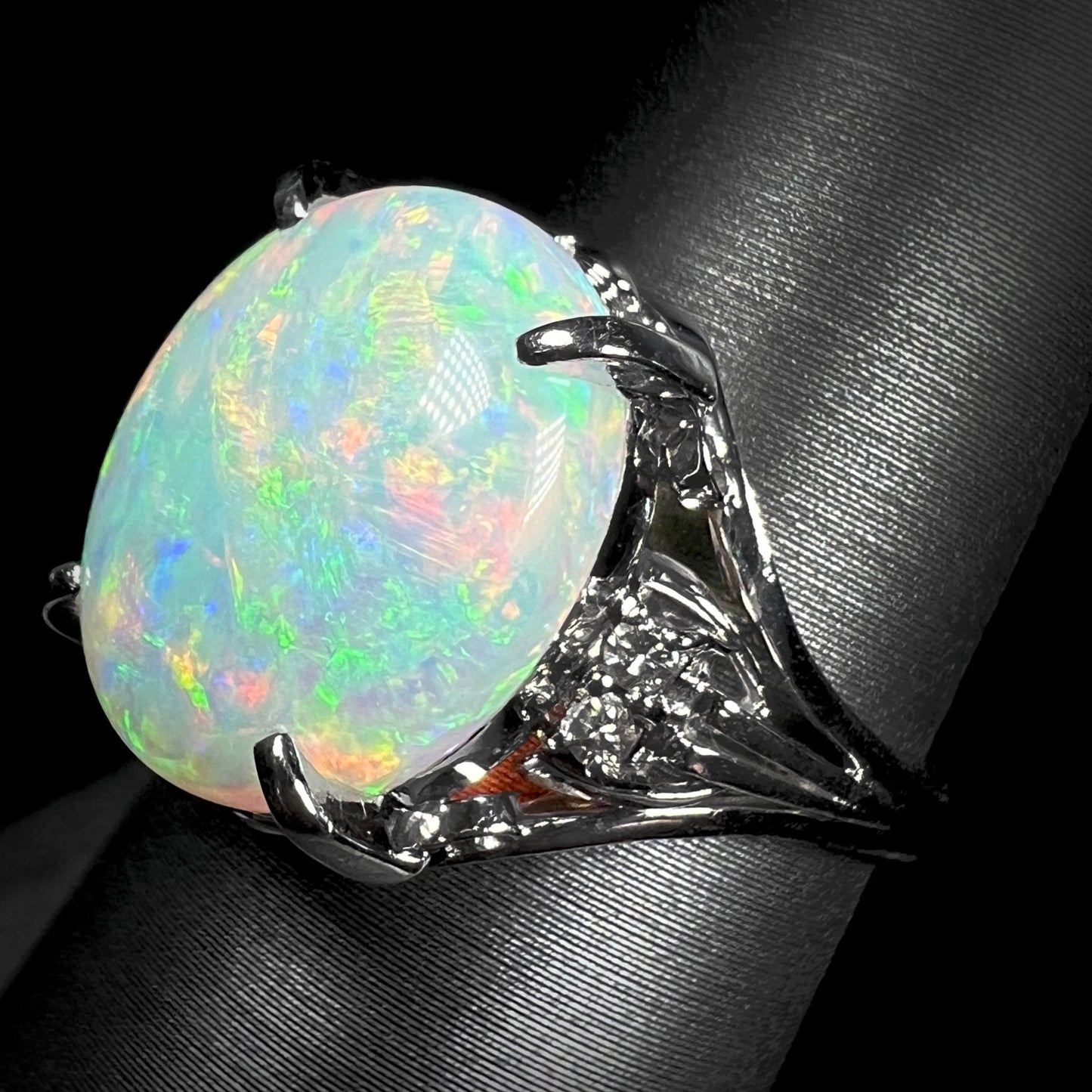 A platinum engagement ring set with a 4.83ct opal and diamond accents.