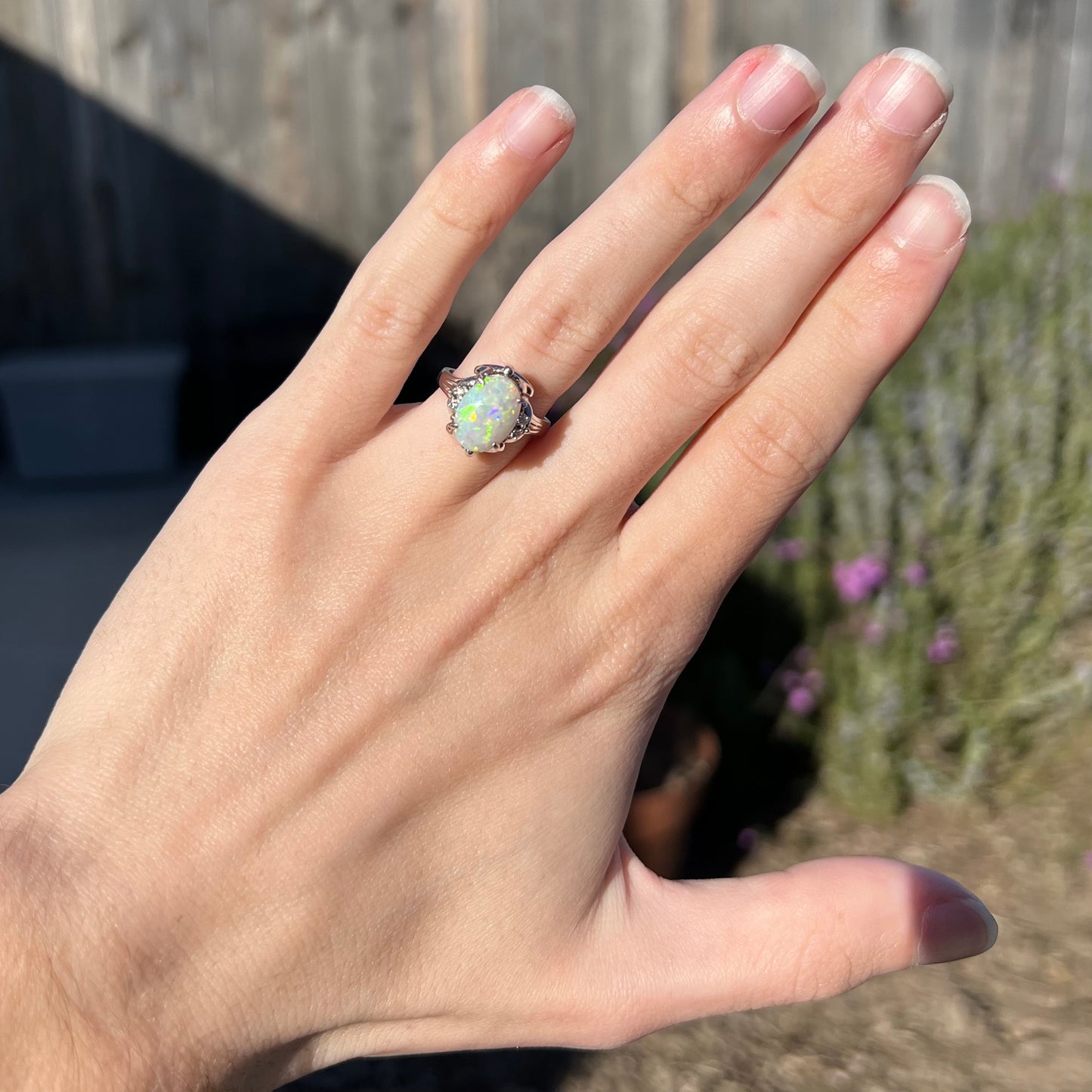 A Japanese-style platinum ring mounted with a Coober Pedy opal and diamond accents.