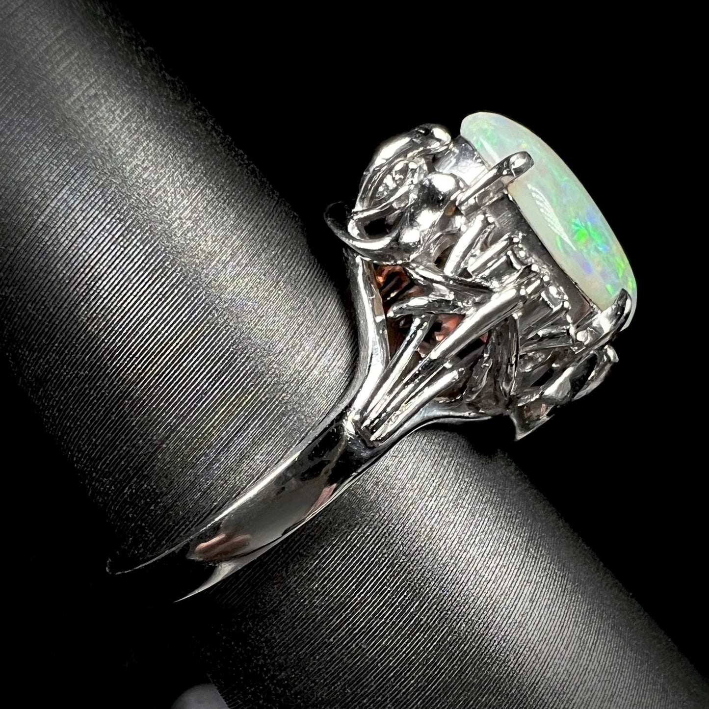 An ornate platinum ring mounted with a natural, 1.89 carat opal.