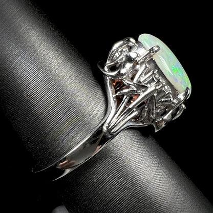 An ornate platinum ring mounted with a natural, 1.89 carat opal.