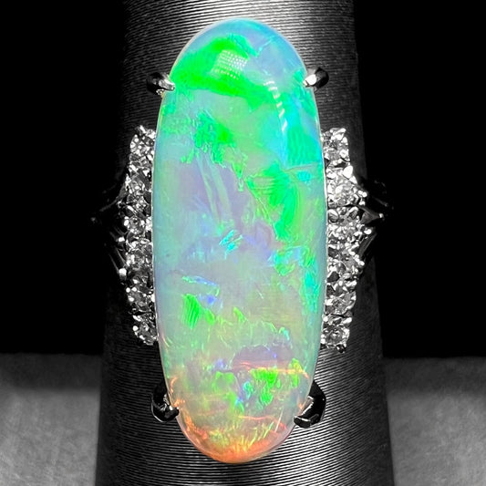 A Lightning Ridge crystal opal platinum ring.  Two rows of diamonds line the opal.