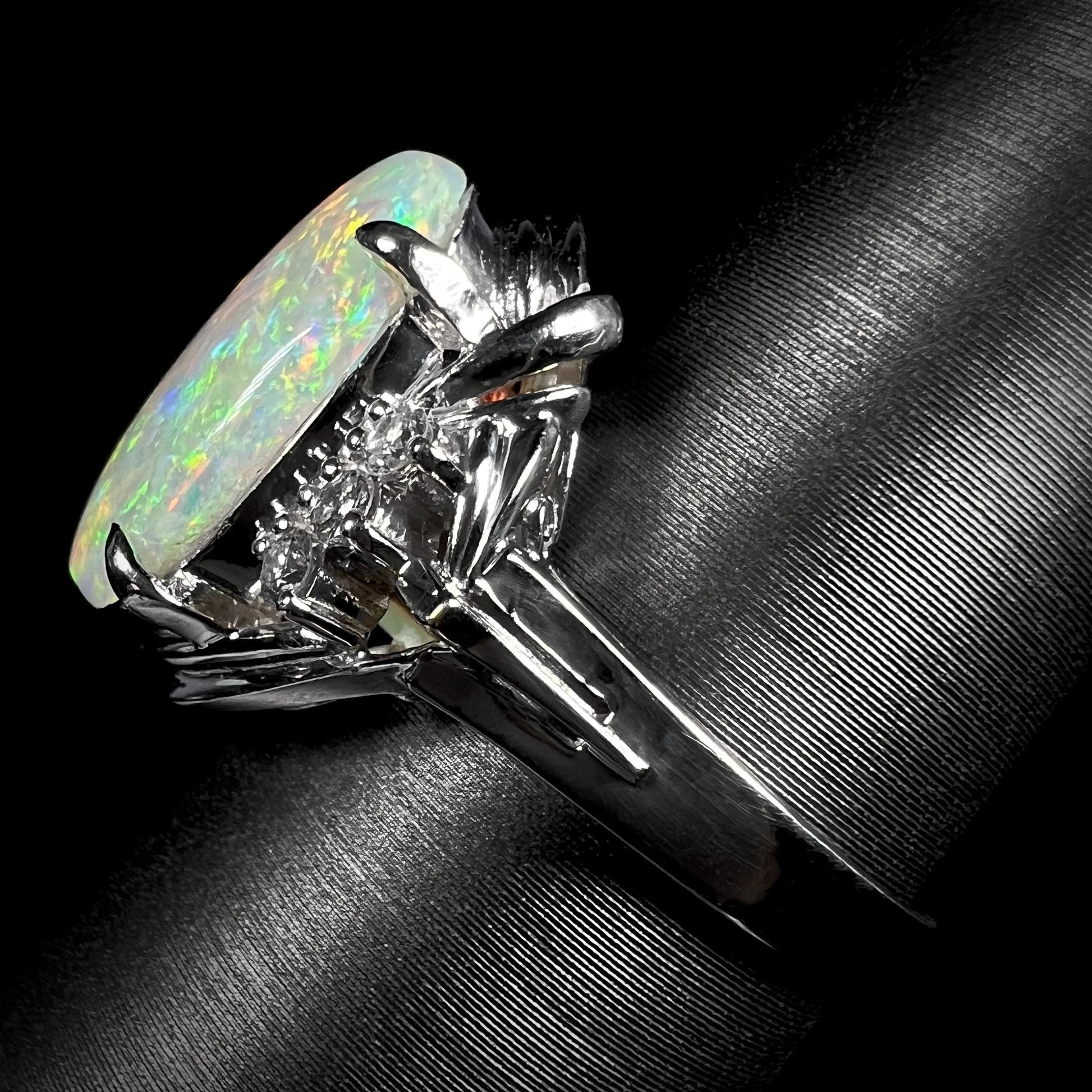 A platinum ring set with a 2.54ct Coober Pedy semi-crystal opal and diamond accents.