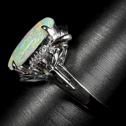 A platinum ring set with a 2.54ct Coober Pedy semi-crystal opal and diamond accents.