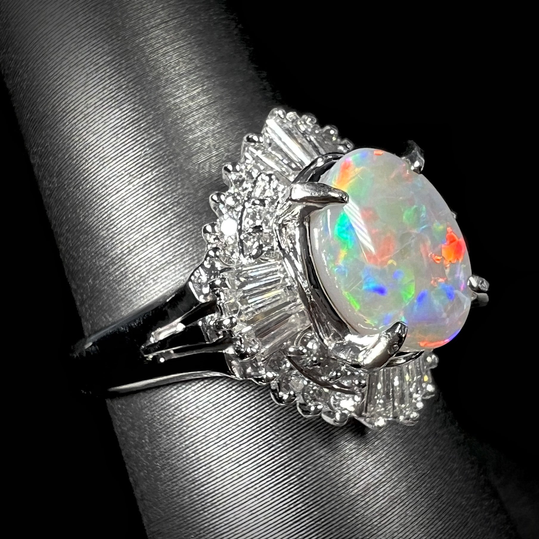 A platinum semi-black opal ring with 40 diamonds, featuring a 1.47ct Lightning Ridge opal with red and blue fire in a vintage spray design.