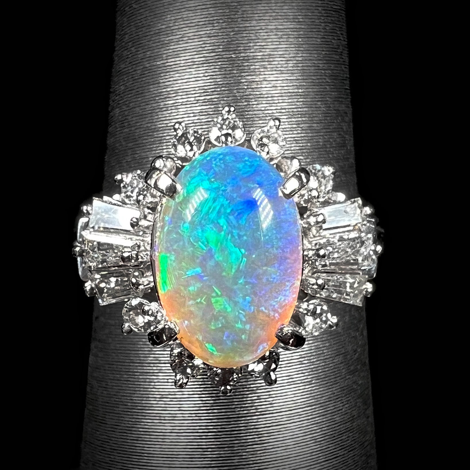 Straight-on view of platinum semi-crystal opal engagement ring showcasing the unique color play of the opal and diamond halo.