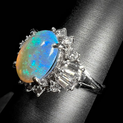 Rotated view of platinum semi-crystal opal engagement ring from the opposite side, with opal showing blue-green color play.