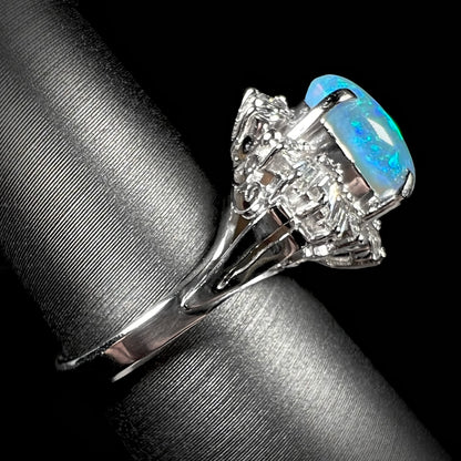 Side view of platinum semi-crystal opal engagement ring showing vintage platinum shank and subtle filigree details.