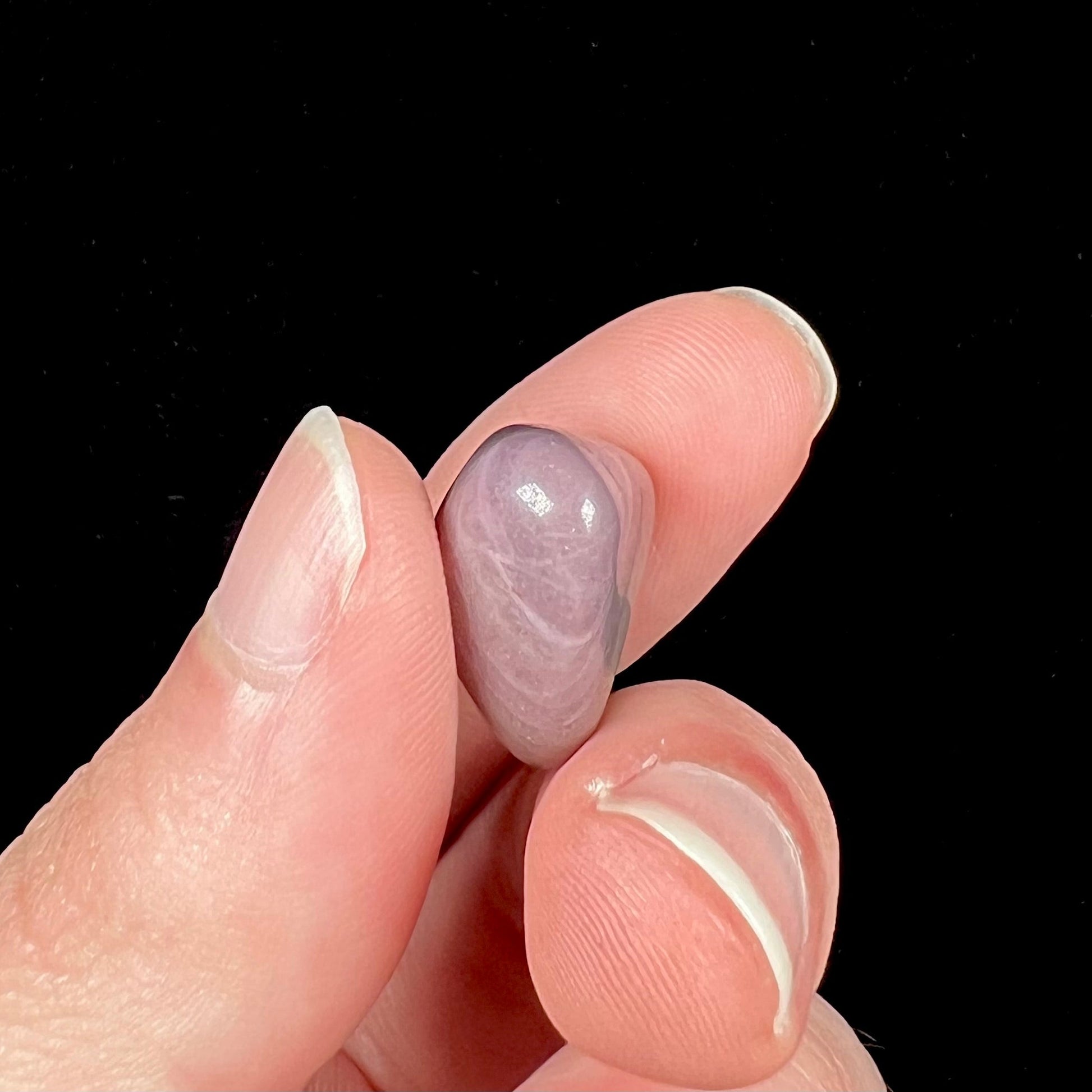 A tumble polished purple and brown turkiyenite jade stone from Bursa, Turkey.