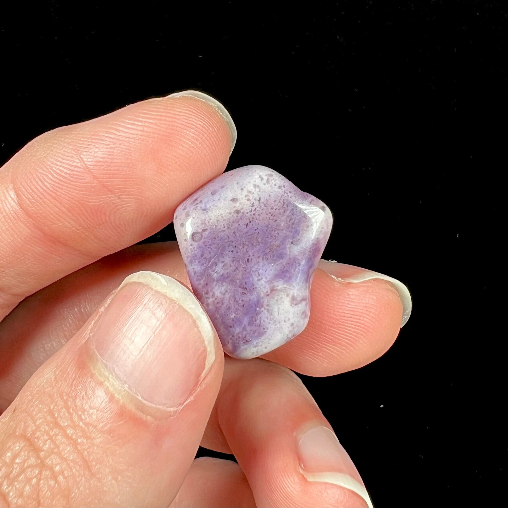 A streaked and spotted purple turkiyenite jade stone from Bursa, Turkey.