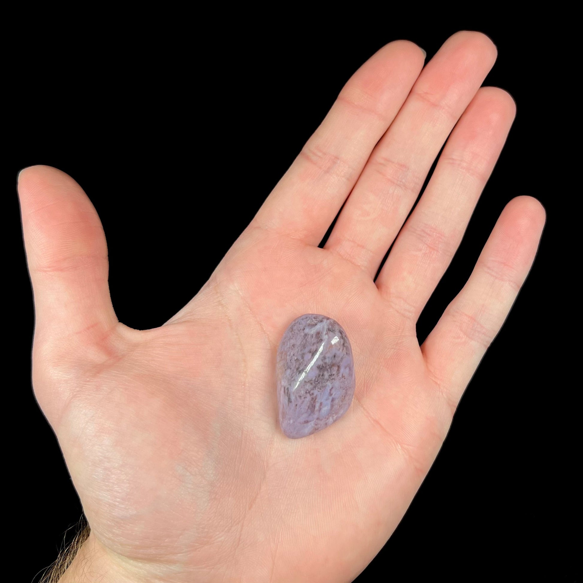 A tumbled purple turkiyenite jade stone from Bursa, Turkey.