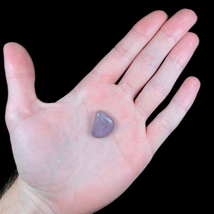 A tumble polished purple turkiyenite jade stone from Bursa, Turkey.