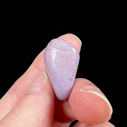 A tumble polished turkiyenite purple jade stone from Bursa, Turkey.